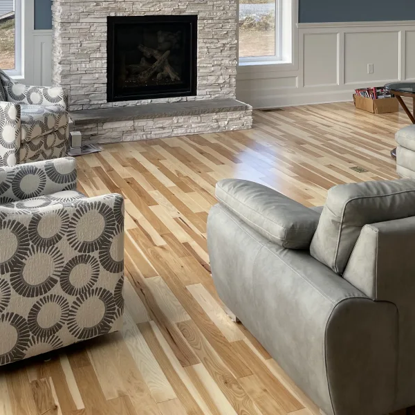 Living room with chairs and sectional couch on hardwood floors