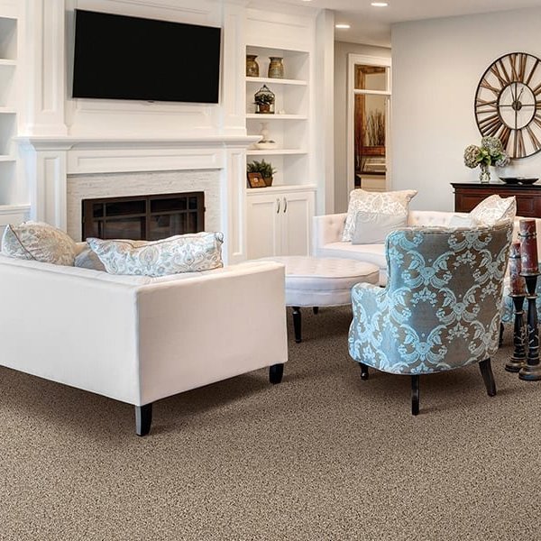 Living room with chairs and sectional couch on carpet