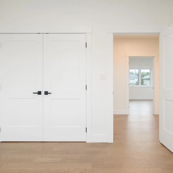 White closet and bedroom doors in a small bedroom