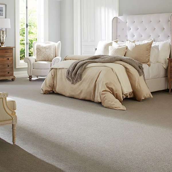 Bedroom with a bed and dresser on carpet